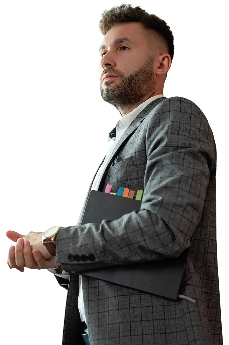 A man in a suit and tie holding a book.